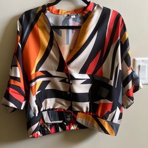 Anni Kuan silky print vneck top with elastic waist in back.